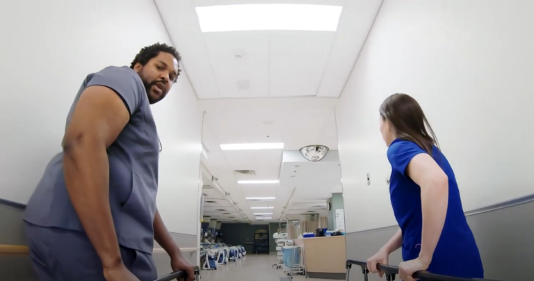 Doctors wheeling patient in bed